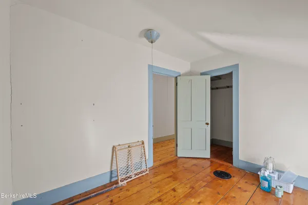 a room with a baby crib furniture and a dresser