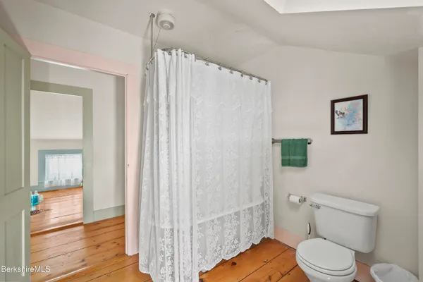 a bathroom with a shower and a glass door