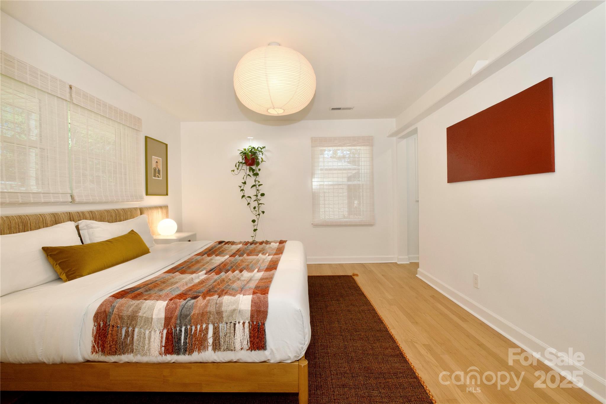 3549 Woodleaf Road Charlotte, NC 28205 - Photo 18 of 43 a bedroom with a bed and wooden floor