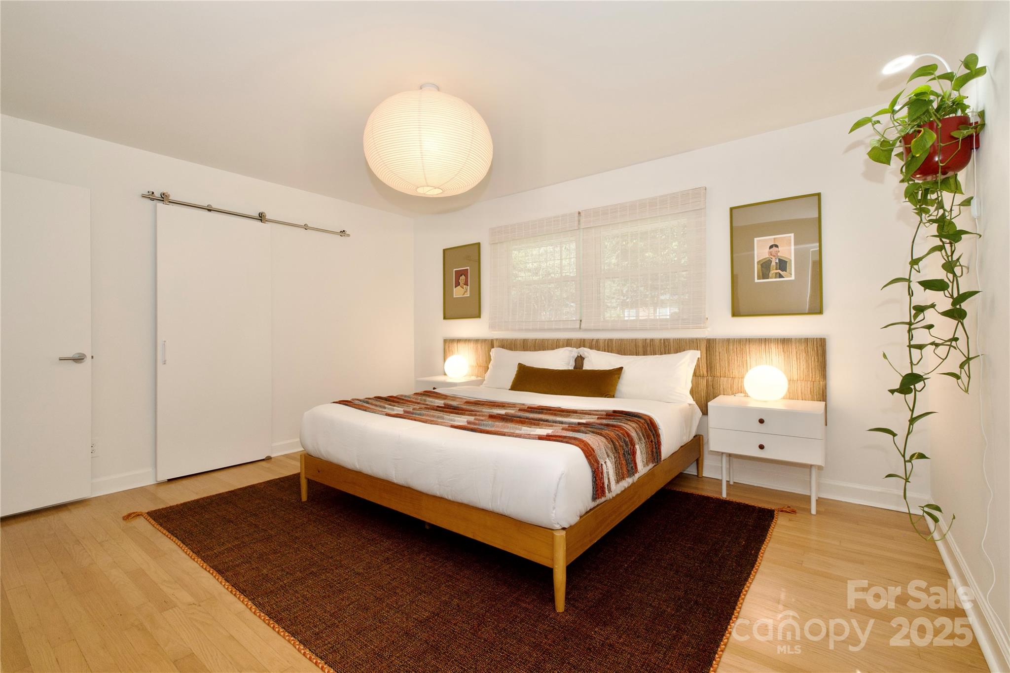 3549 Woodleaf Road Charlotte, NC 28205 - Photo 19 of 43 a bedroom with a bed and a potted plant