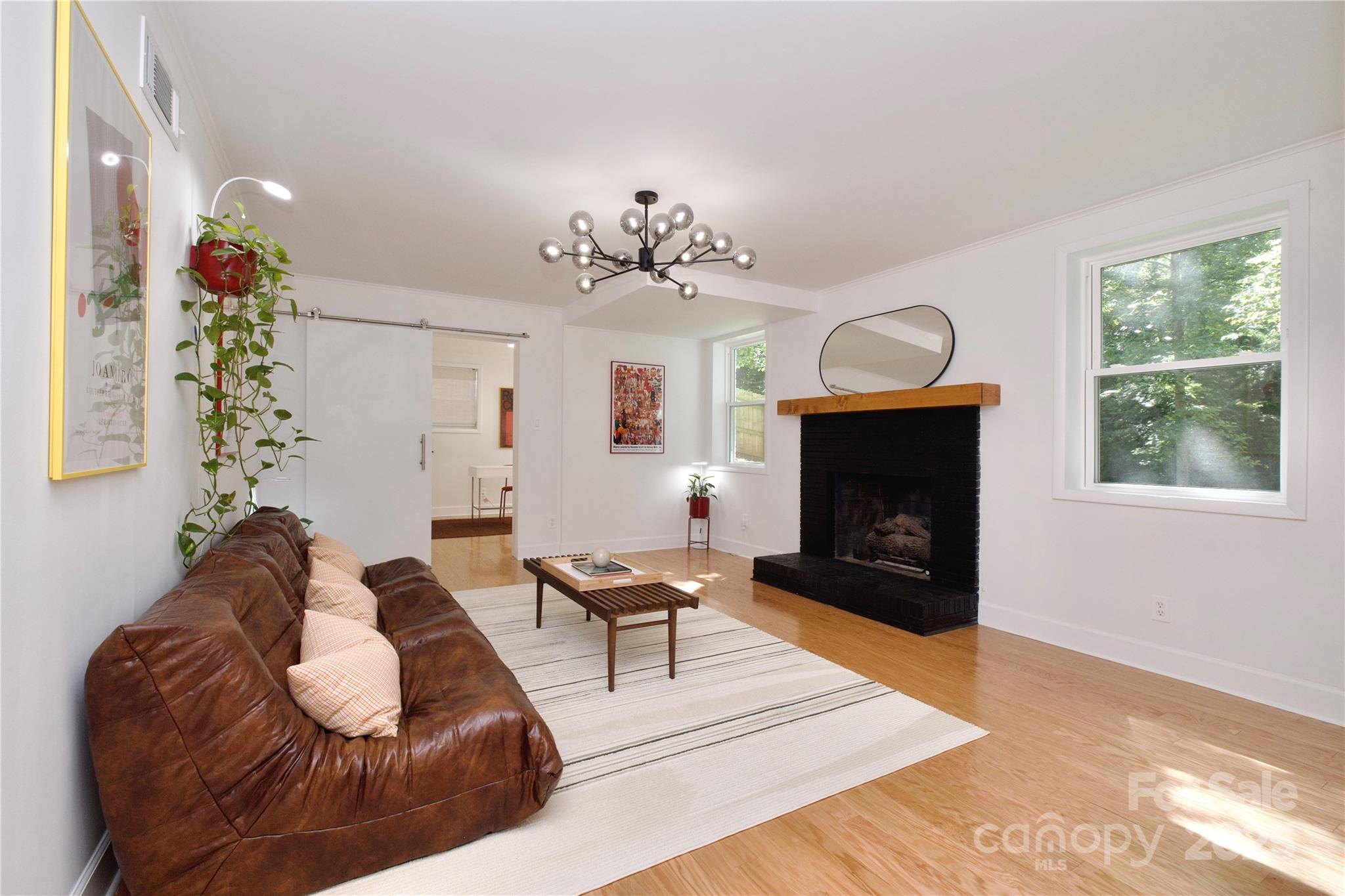 3549 Woodleaf Road Charlotte, NC 28205 - Photo 32 of 43 a living room with furniture a fireplace and a window
