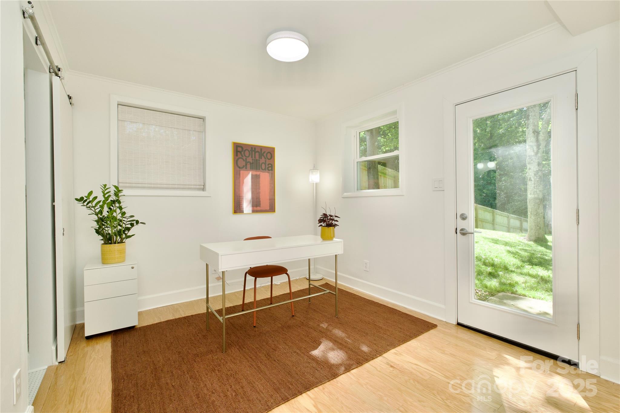 3549 Woodleaf Road Charlotte, NC 28205 - Photo 33 of 43 a view of a livingroom with a window and wooden floor