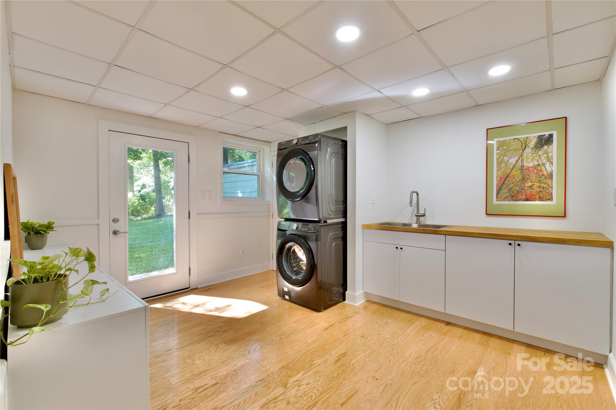3549 Woodleaf Road Charlotte, NC 28205 - Photo 38 of 43 a bedroom with a bed and a chandelier