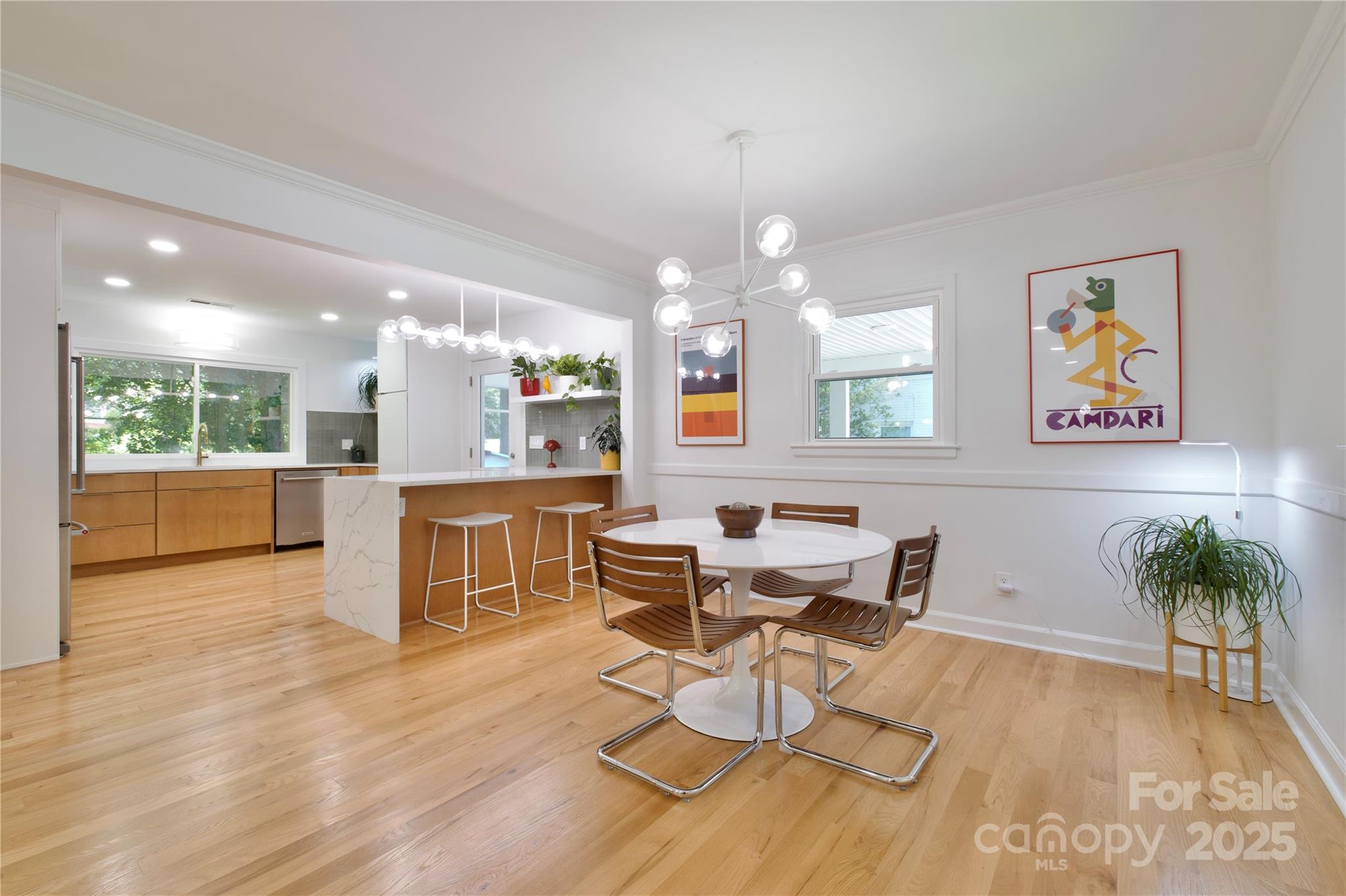 3549 Woodleaf Road Charlotte, NC 28205 - Photo 10 of 43 a view of a dining room with furniture a kitchen and chandelier