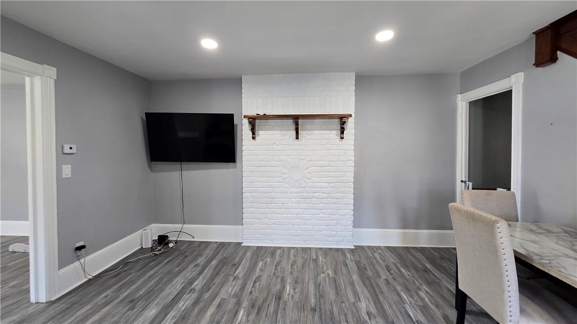 883 North Locust Street Hazleton, PA 18201 - Photo 16 of 83 A striking white brick fireplace with an ornate wood mantel grounds this welcoming living space.