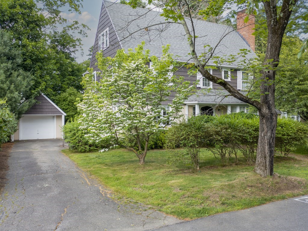 14 Birch Road Wellesley, MA 02482 - Photo 1 of 18 a backyard of a house with plants and large trees