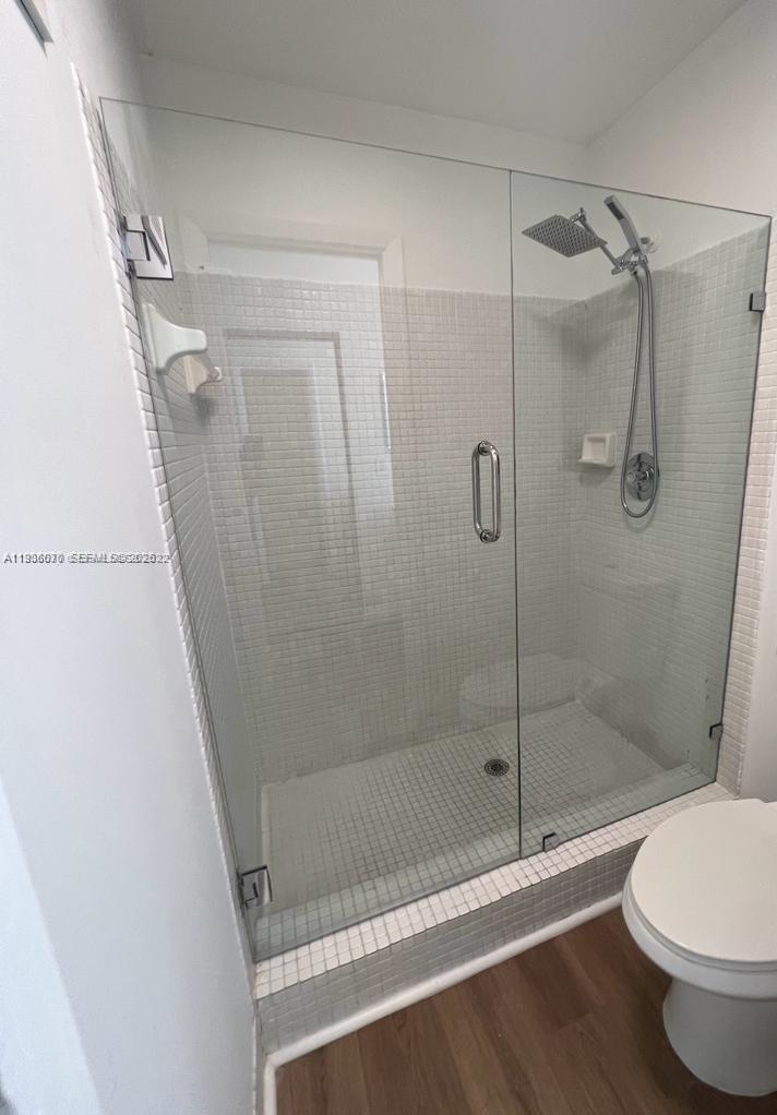 9727 Hammocks Boulevard, Unit 202D Miami, FL 33196 - Photo 12 of 16 a bathroom with a shower and a toilet
