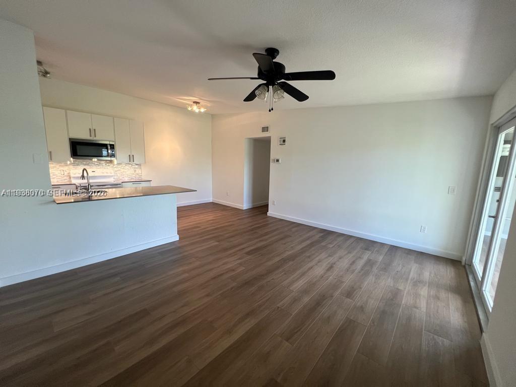 9727 Hammocks Boulevard, Unit 202D Miami, FL 33196 - Photo 13 of 16 a view of empty room with wooden floor and window