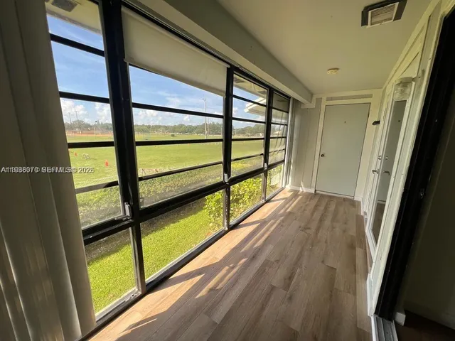a view of hallway with wooden floor