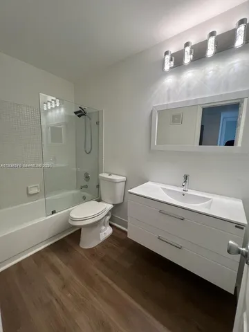 a bathroom with a toilet a sink and bathtub