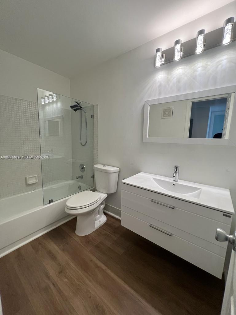 9727 Hammocks Boulevard, Unit 202D Miami, FL 33196 - Photo 8 of 16 a bathroom with a toilet a sink and bathtub