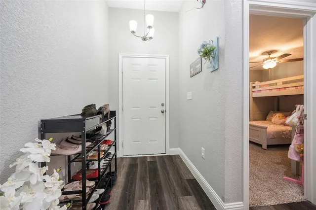 a view of a hallway with workspace and a window