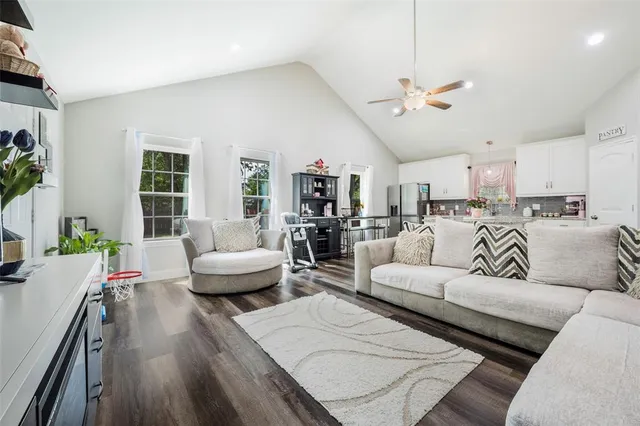 a living room with furniture and a wooden floor
