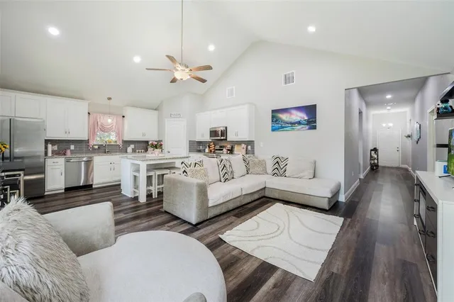 a living room with furniture and kitchen view