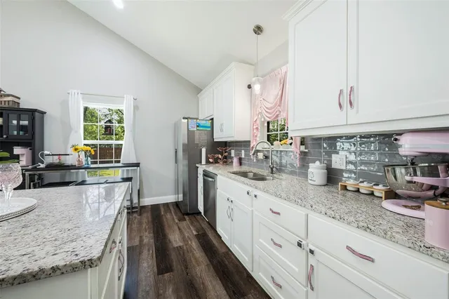 a kitchen with sink stove and cabinets