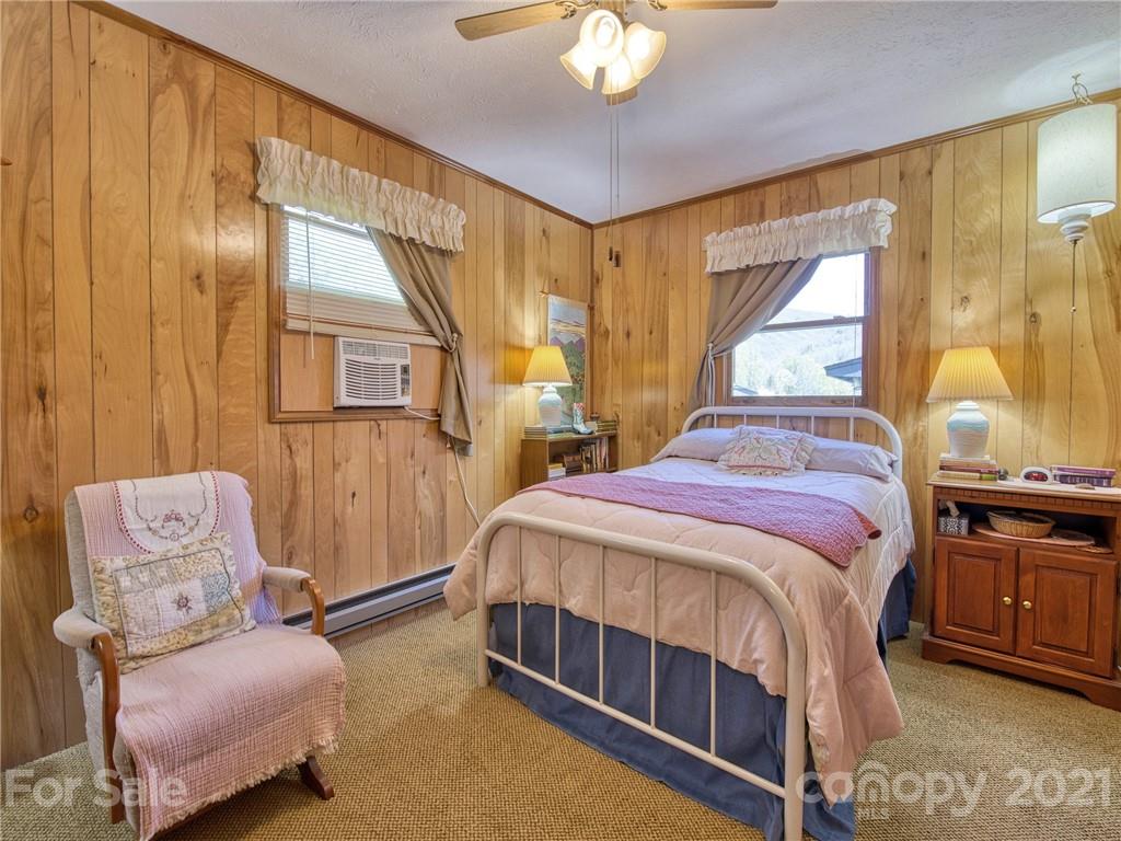 444 Stoney Ridge Loop Maggie Valley, NC 28751 - Photo 17 of 25 a spacious bedroom with a bed and wooden floor