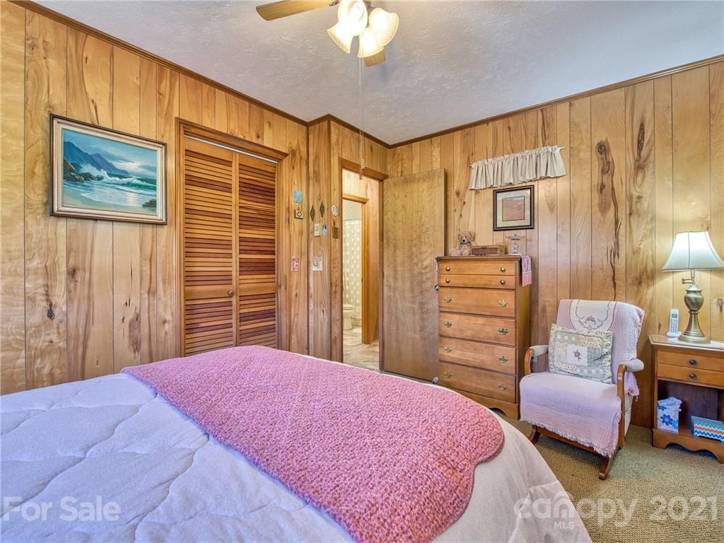 444 Stoney Ridge Loop Maggie Valley, NC 28751 - Photo 18 of 25 a bedroom with a bed and furniture