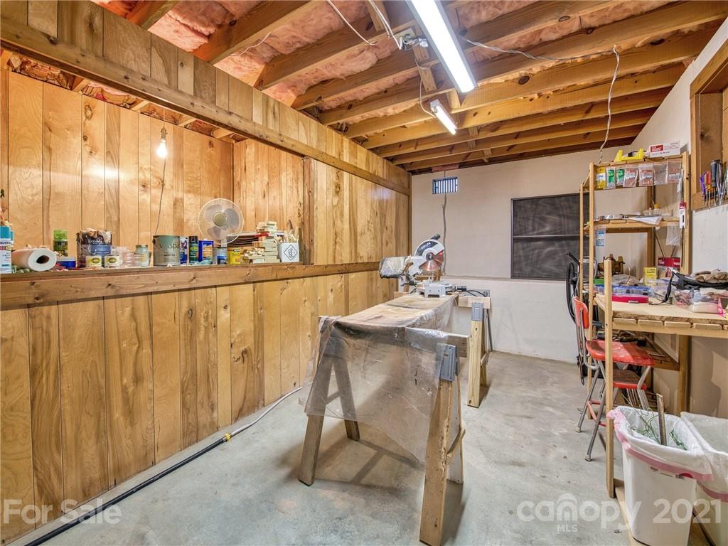 444 Stoney Ridge Loop Maggie Valley, NC 28751 - Photo 21 of 25 a dining hall with stainless steel appliances granite countertop a sink cabinets and wooden floor