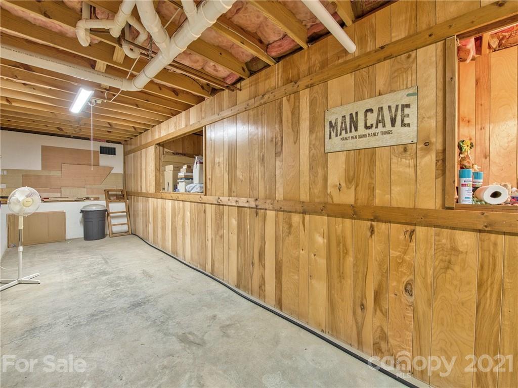 444 Stoney Ridge Loop Maggie Valley, NC 28751 - Photo 22 of 25 a view of a garage with wooden walls
