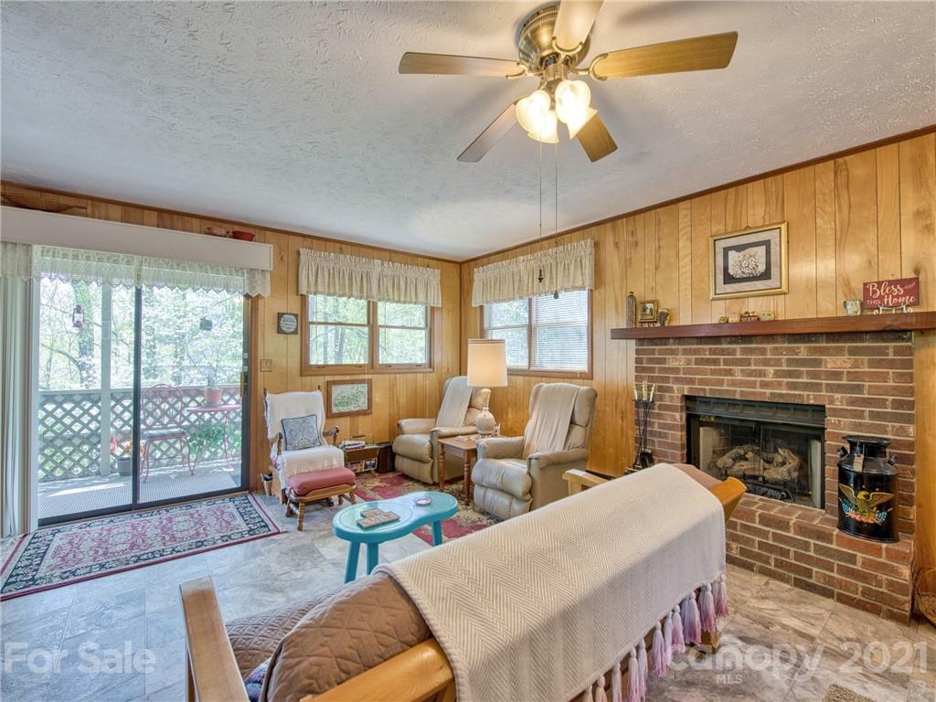 444 Stoney Ridge Loop Maggie Valley, NC 28751 - Photo 5 of 25 a living room with furniture and a fireplace