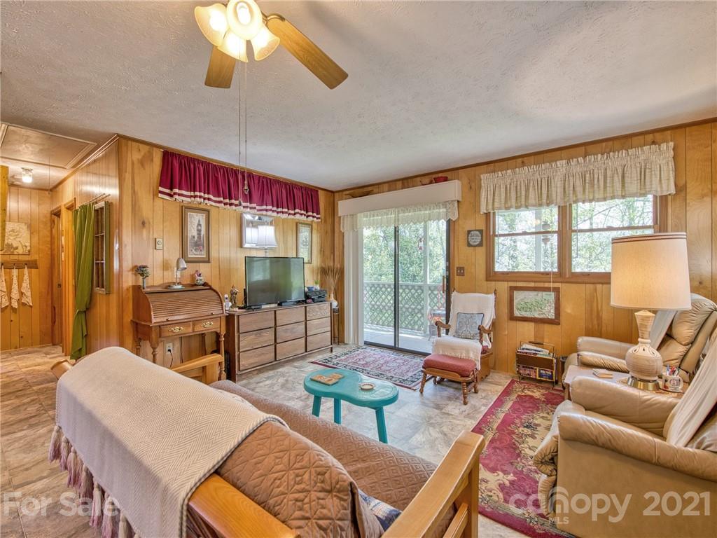 444 Stoney Ridge Loop Maggie Valley, NC 28751 - Photo 6 of 25 a living room with furniture and a floor to ceiling window