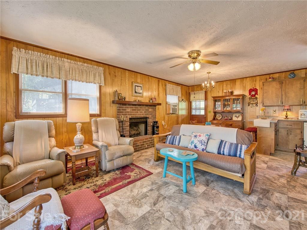 444 Stoney Ridge Loop Maggie Valley, NC 28751 - Photo 7 of 25 a living room with furniture or couch and a fireplace