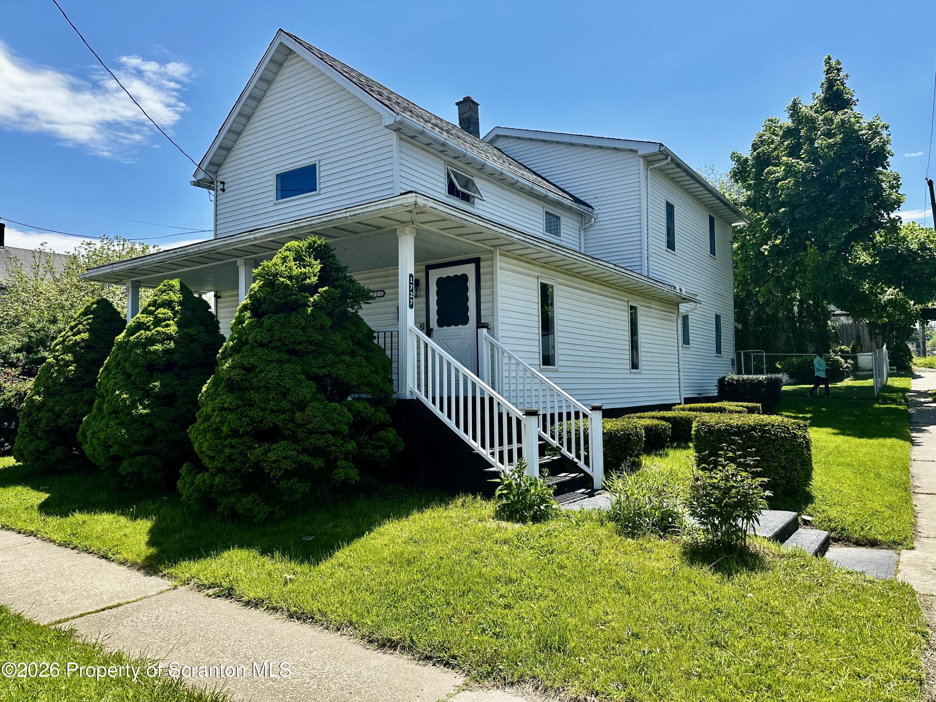 a front view of house with yard and green space