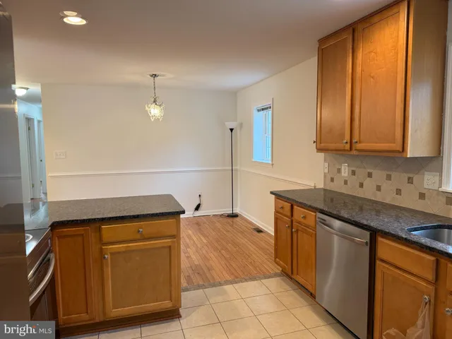 a kitchen with stainless steel appliances granite countertop a sink and cabinets