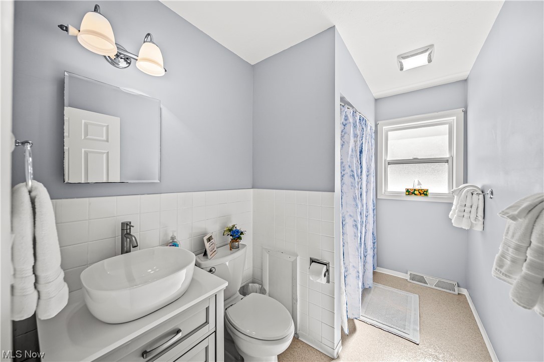 6882 Pymatuning Lake Road Andover, OH 44003 - Photo 21 of 25 Bathroom featuring large vanity, tile walls, and toilet