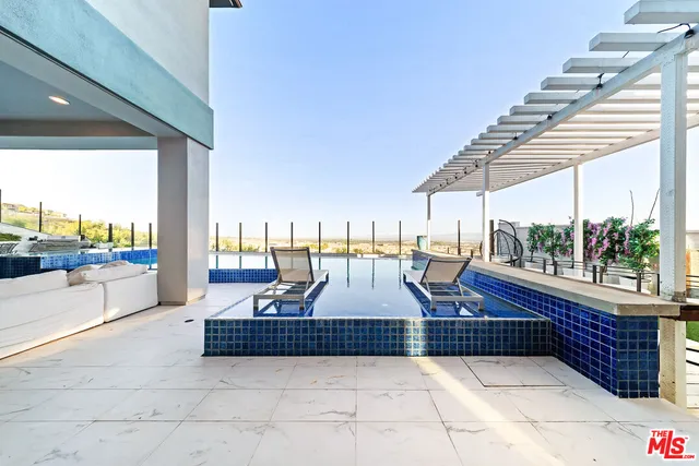 a view of outdoor space with seating space and swimming pool