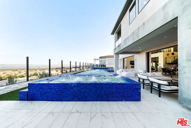 a swimming pool with outdoor seating and yard