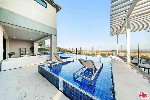 a view of a house with patio and a yard