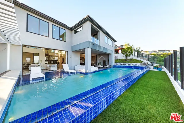 a large kitchen with lots of counter space and dining table