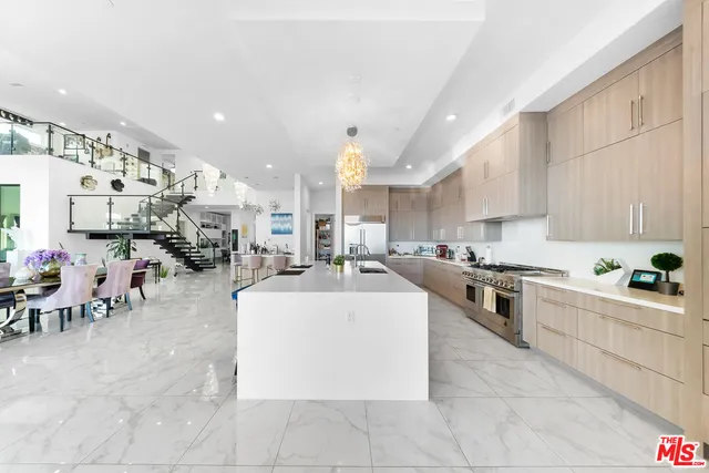 a large kitchen with lots of counter and chairs