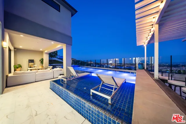 a view of a swimming pool with outdoor seating