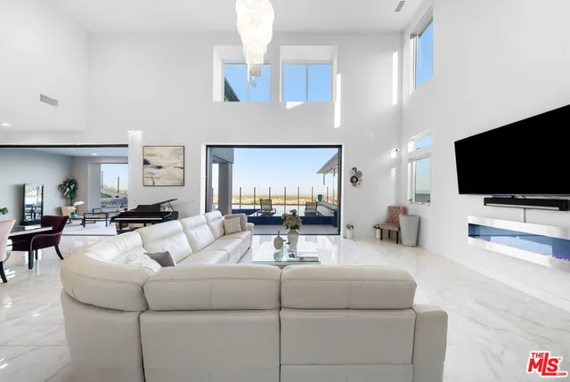 a living room with lots of furniture and a large window