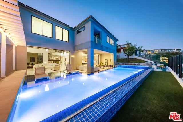 a view of swimming pool with chairs