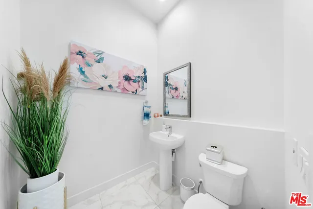 a bathroom with a sink mirror toilet and shower