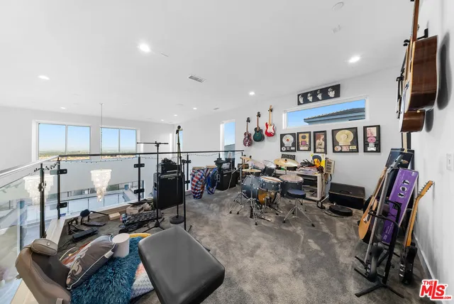 a living room with furniture and a dresser