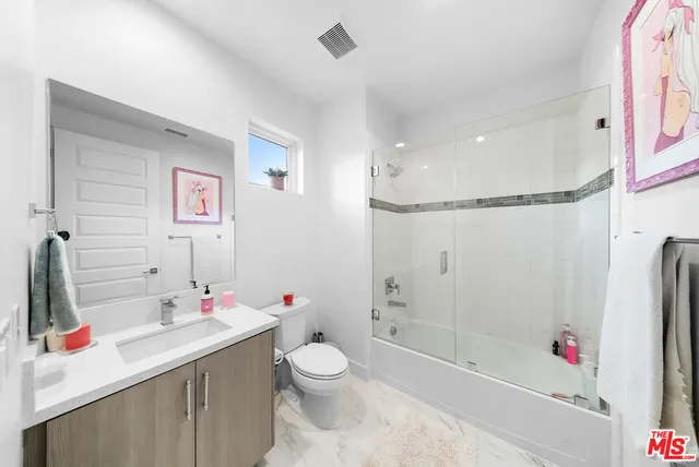 a large kitchen with a sink and cabinets