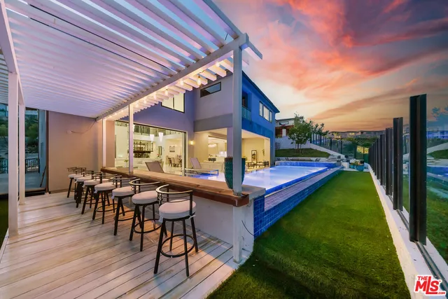 a view of a patio with table and chairs floor to ceiling window with wooden floor
