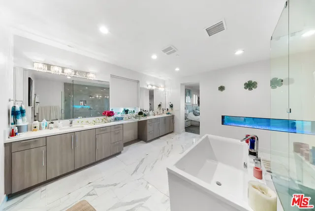 a large kitchen with a large counter top stainless steel appliances and view kitchen