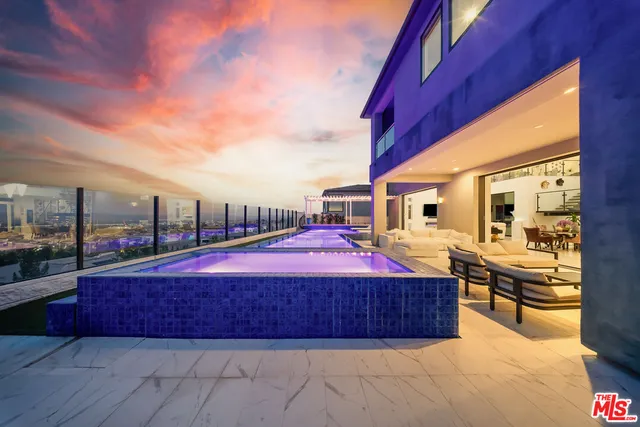 a swimming pool with outdoor seating