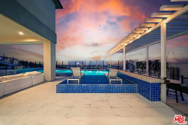 a view of a patio with a table and chairs