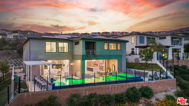 a view of a house with a yard and potted plants