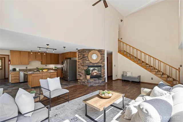 a living room with lots of furniture and view of kitchen