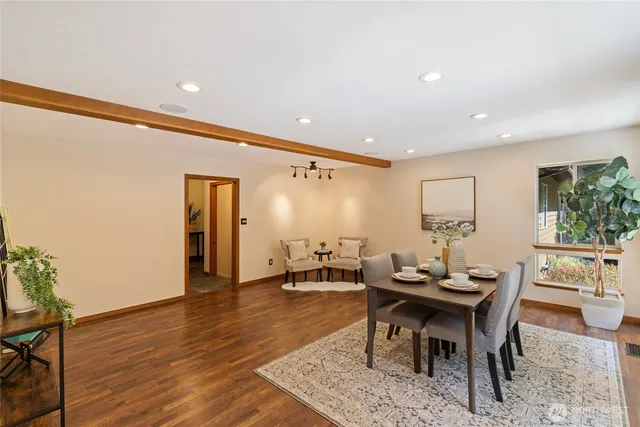 a dining room with furniture and wooden floor