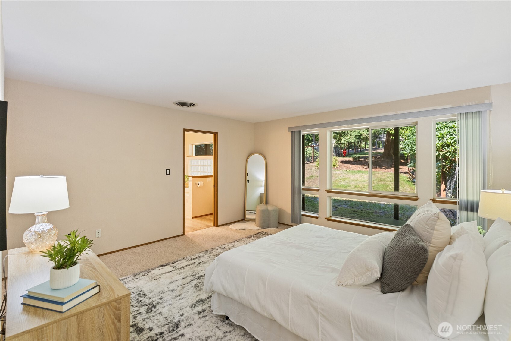20 Bluebird Lane Port Ludlow, WA 98365 - Photo 21 of 40 a bedroom with a bed mirror and a large window