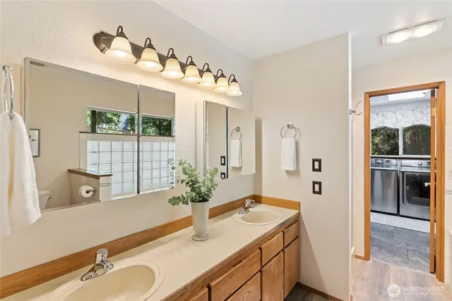 a bathroom with a tub sink and mirror