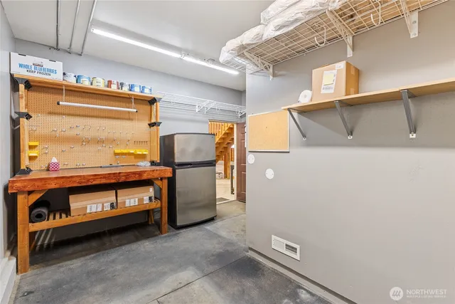 an aerial view of residential house with outdoor space and trees all around